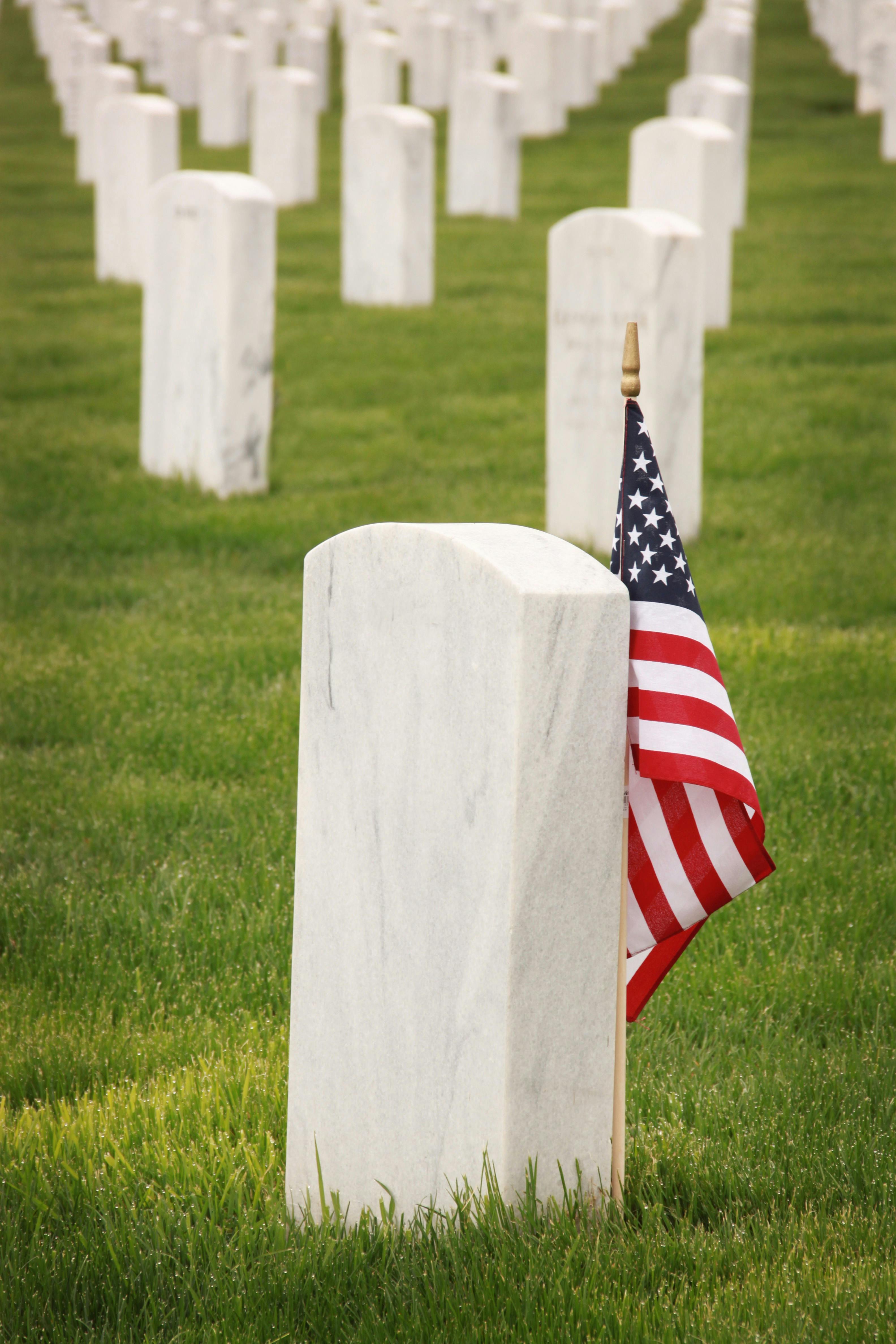 cemetery headstones with American flag