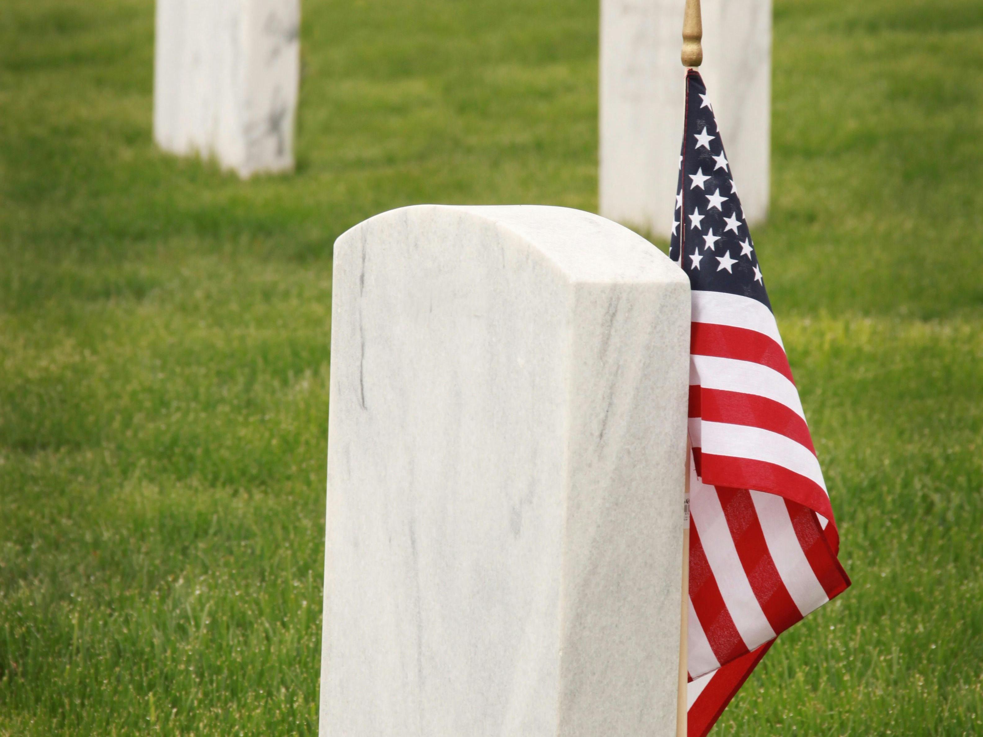 cemetery headstones with American flag