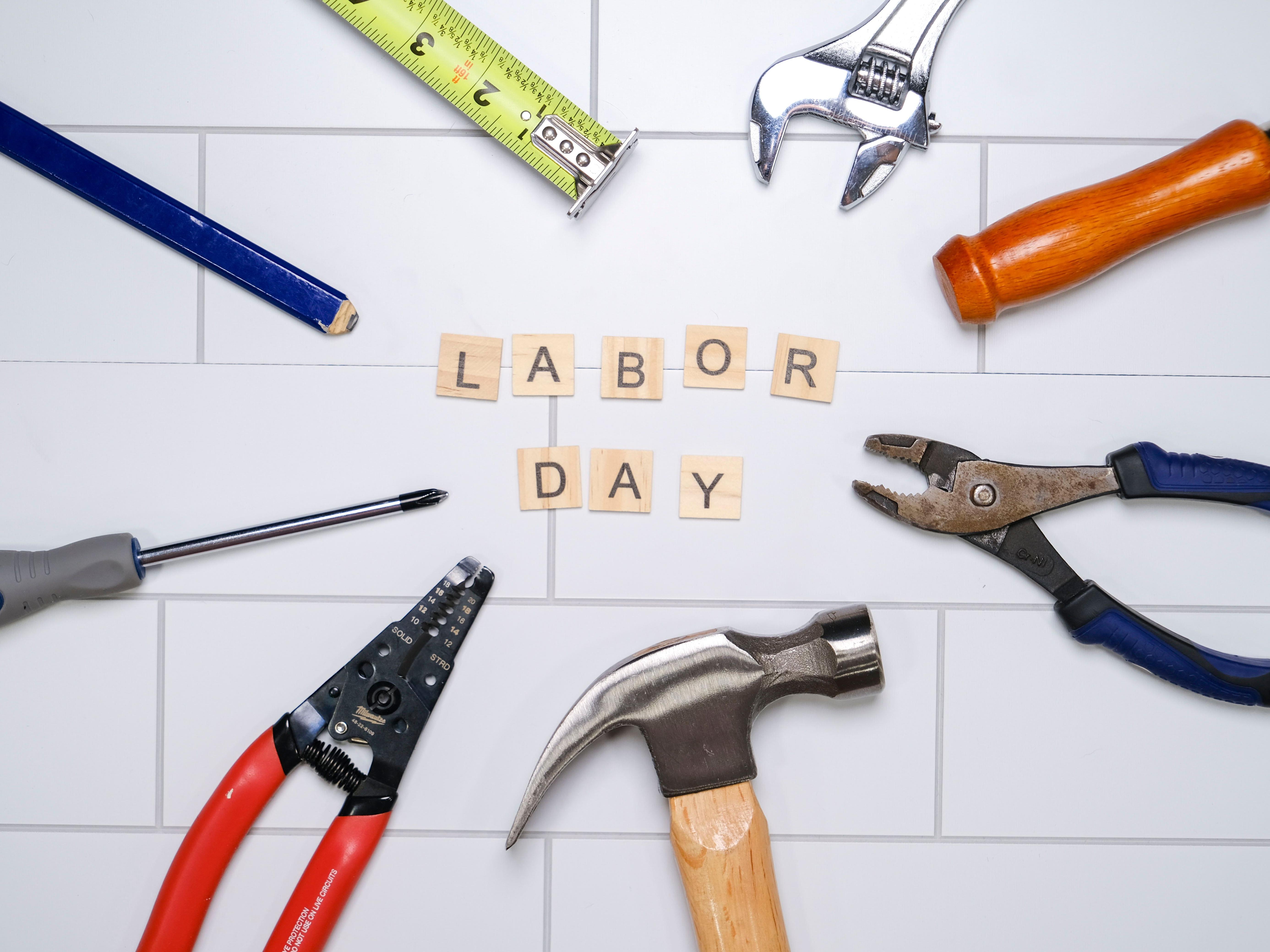 Labor Day spelled out on scrabble tiles surrounded by tools